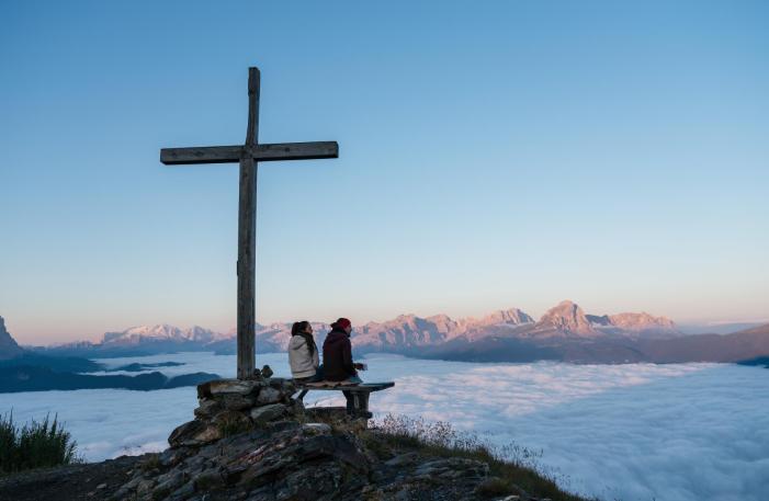 A couple at the peak of a mountain