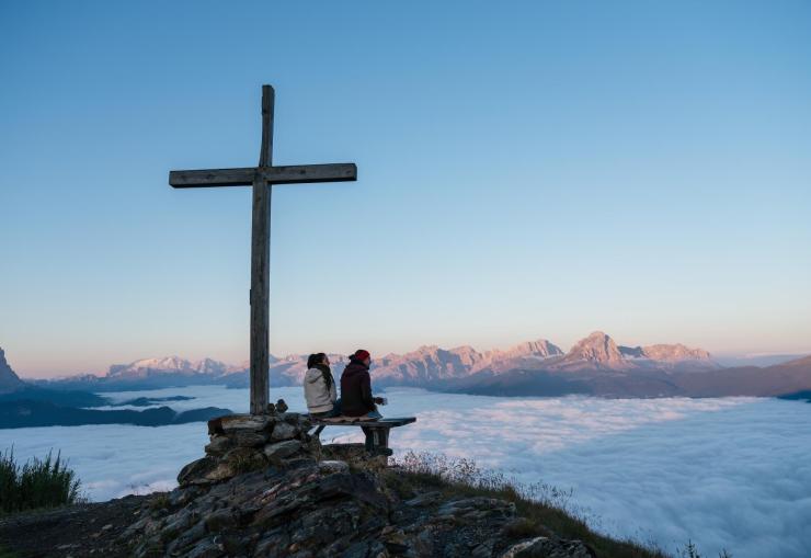 A couple at the peak of a mountain
