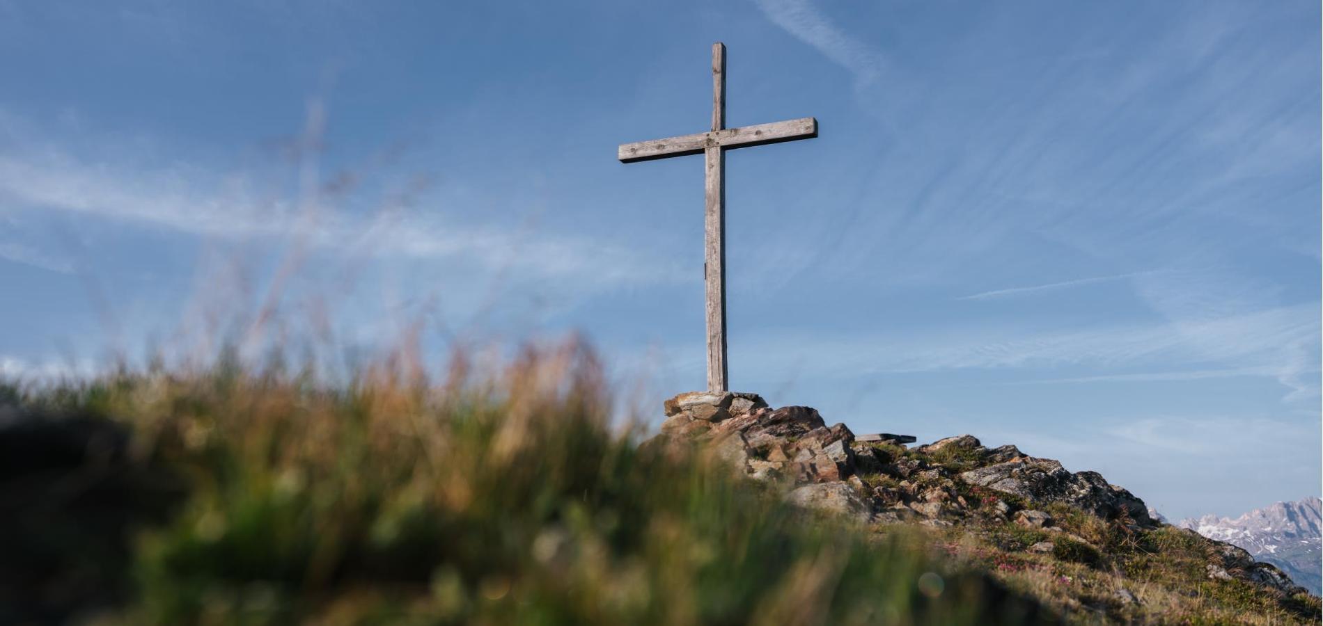 The cross at the peak of a mountain